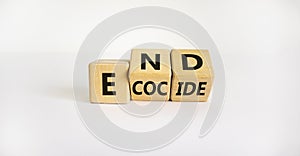 End ecocide symbol. Turned wooden cubes with words end ecocide. Beautiful white background, copy space. Business, ecological and