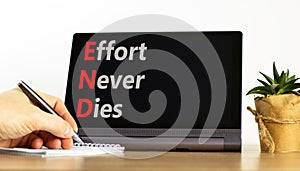 END effort never dies symbol. Concept words END effort never dies on beautiful black tablet. Beautiful white background.