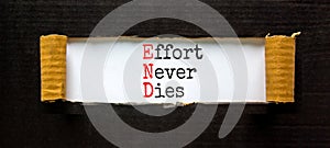 END effort never dies symbol. Concept words END effort never dies on beautiful white paper. Beautiful black paper background.