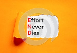 END effort never dies symbol. Concept words END effort never dies on beautiful white paper. Beautiful orange paper background.