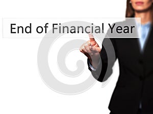 End of Financial Year - Businesswoman hand pressing button on to