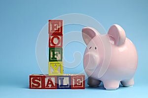 End of Financial Year sale message on building blocks with piggy bank