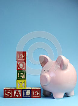 End of Financial Year sale message on building blocks with piggy bank - vertical with copy space.