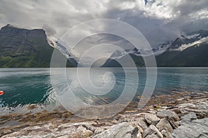 End of fjord. Beautiful Norwegian landscape. view of the fjords. Norway ideal fjord reflection in clear water In cloudy weather.