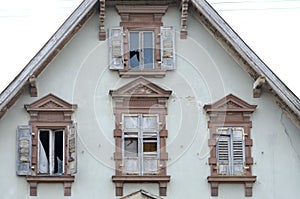 End gable and windows of an old abandoned house