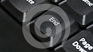 End key on a desktop PC office computer keyboard, the end button macro, detail, extreme closeup. Ending, finishing, closing or