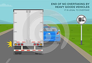 End of no overtaking by heavy goods vehicles sign meaning. Back view of a truck passing car on road.