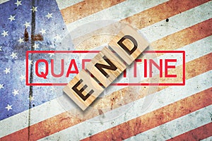 End of quarantine. The inscription on wooden blocks on the background of the flag of America. The end of the pandemic. Business