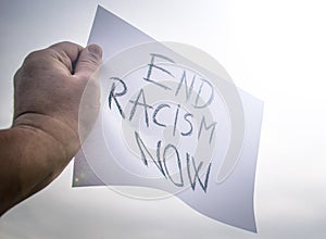 End Racism Now- message written on a banner