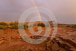 The end of the rainbow arcs over Gooseberry Mesa in Southern Utah USA