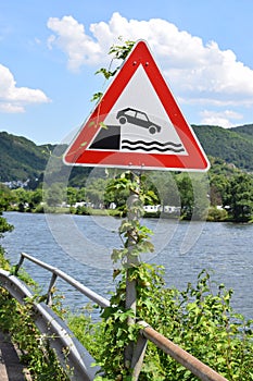 end of the road warning sign with vine growing up on it