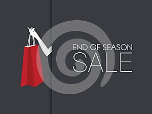 End of season sale banner with hand holding shopping bag and black background.