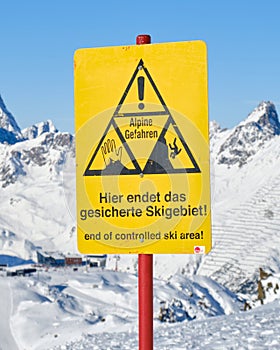 End of a ski area warning sign on ski slope, in German, at Ischgl ski resort, on the border of Austria and Switzerland