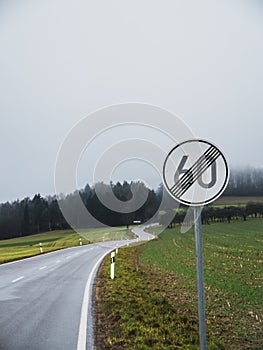 End of speed limit with curvy road