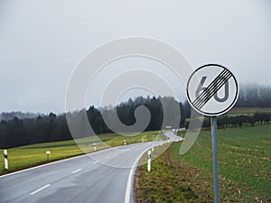 End of speed limit with curvy road