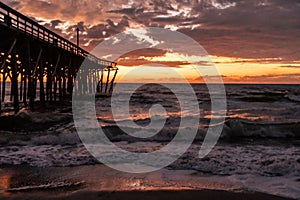 Sunrise and The damaged fishing pier on Pawley's Island, South Carolina