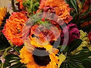 End of summer flower arrangement - sunflowers, peach roses, purple puffy flowers,