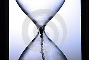 End of times on hourglass closeup photo