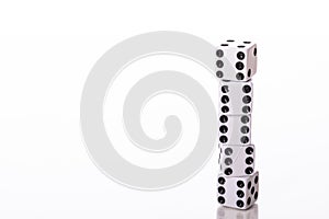 End to end Stack of five white dice black pips showing six
