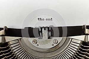 `the end` typed words on a vintage typewriter
