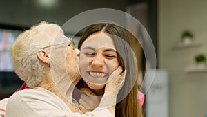 Endearing image of a grandmother kissing her granddaughter