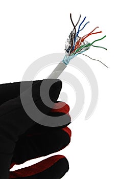 Ending of shielded lan network cable STP cat 5E held in left hand in black glove, white background.