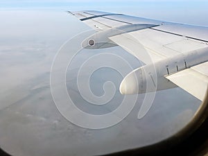 Endless clouds and blue sky under the wing of the plane