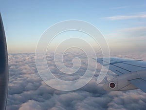 Endless clouds and blue sky under the wing of the plane