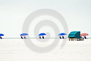 An endless deserted white sand beach and a number of lounge chairs for relaxation. minimalistic landscape. paradise vacation. Flor