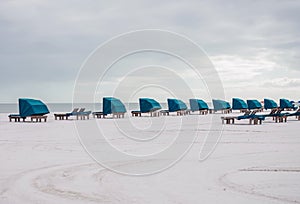 An endless deserted white sand beach and a number of lounge chairs for relaxation. minimalistic landscape. paradise vacation. Flor