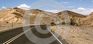 Endless empty road scenic landscape with a desert and mountains in the background in Nevada