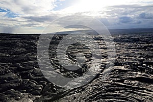 Endless lava fields of the Big Isalnd of Hawaii. Smooth, undulating surface of frozen pahoehoe lava. photo