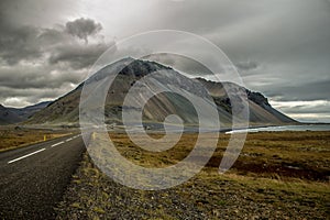 Endless road at the coast with mountain