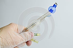 Endobronchial intubation tube with inflated cuffs held in left hand in sterile glove