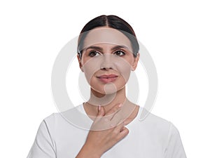Endocrine system. Young woman doing thyroid self examination on white background