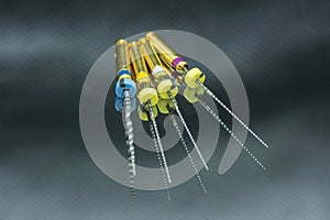 Endodontic needles for the treatment of pulpitis and tooth roots close-up on a black background. Tooth canal instrumentation