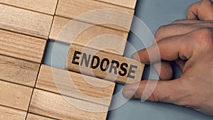 ENDORSE word concept. Close-up wooden piece blocks on the table photo