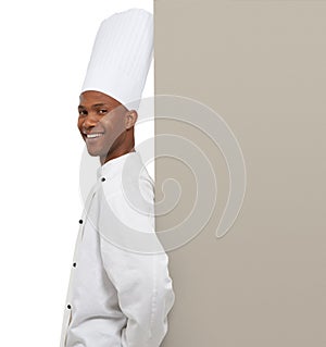 Endorsing your copyspace. A young chef leaning against your copyspace. photo