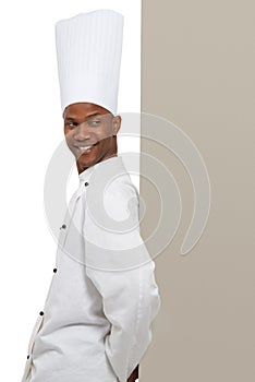 Endorsing your copyspace. A young chef leaning against your copyspace. photo