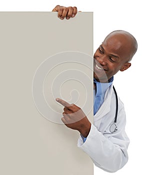 Endorsing your healthcare message. A young african doctor pointing to an area reserved for copyspace. photo