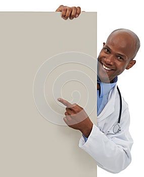 Endorsing your healthcare message. A young doctor pointing at an area reserved for copyspace.