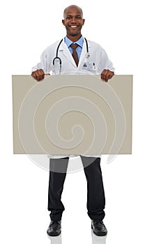 Endorsing your healthcare message. A young male doctor holding up a blank board.