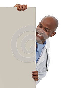 Endorsing your healthcare message. A young male doctor standing behind a board reserved for copyspace. photo