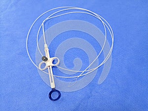 Endoscopic Instrument Polypectomy Snare In Blue Background. Selective Focus