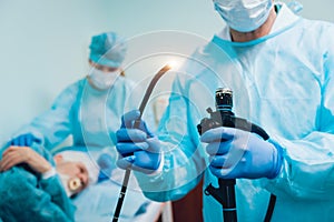 Endoscopy at the hospital. Doctor holding endoscope before gastroscopy photo