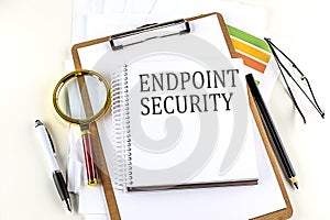 ENDPOINT SECURITY text on notebook with clipboard on white background