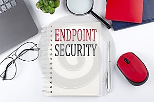 ENDPOINT SECURITY text on a notepad with laptop on the white background