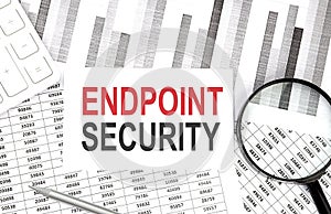 ENDPOINT SECURITY text on paper with calculator,magnifier ,pen on graph background