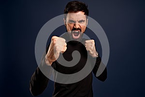 Endurance, motivated and power concept. Good-looking bearded man ready for fight, looking excited and determined, standing in