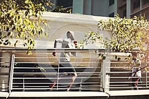 Endure further, carry on until you reach your goals. a handsome young man running on a bridge in the city.